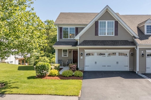 15 Herrick Dr Unit 15, Methuen, MA 01844 - view of front of home with driveway, a front yard, roof with shingles, an attached garage, and a porch
