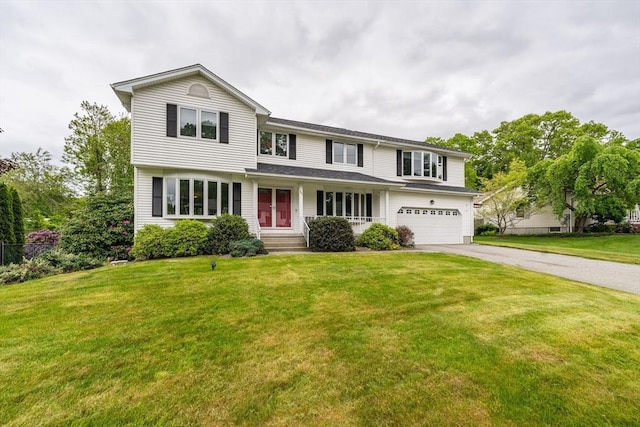 35 Dejordy Ln, Chicopee, MA 01020 - traditional home featuring asphalt driveway, a garage, and a front yard