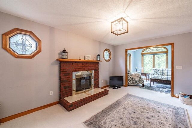 35 Dejordy Ln, Chicopee, MA 01020 - carpeted living room featuring a brick fireplace, baseboards, and a textured ceiling