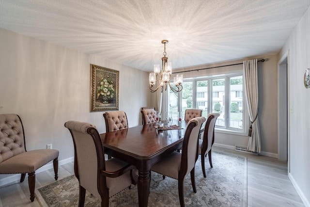 35 Dejordy Ln, Chicopee, MA 01020 - dining room with a chandelier, baseboards, and light wood-type flooring