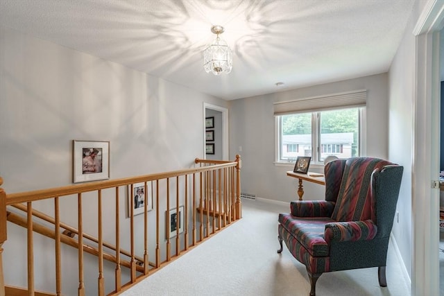 35 Dejordy Ln, Chicopee, MA 01020 - hallway featuring an upstairs landing, a chandelier, carpet flooring, and baseboards