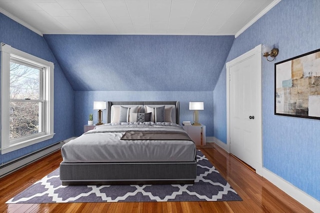 bedroom featuring vaulted ceiling, crown molding, wood finished floors, and baseboards