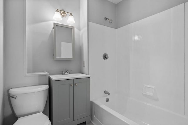 bathroom featuring vanity, toilet, and bathing tub / shower combination