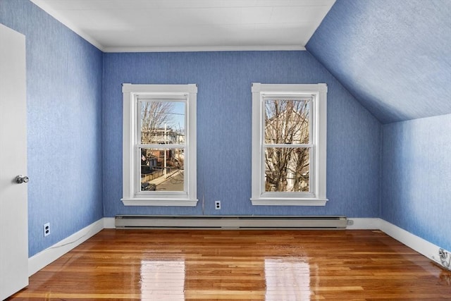 bonus room featuring vaulted ceiling, wood finished floors, baseboards, and baseboard heating