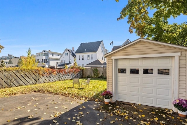 garage with a residential view and fence