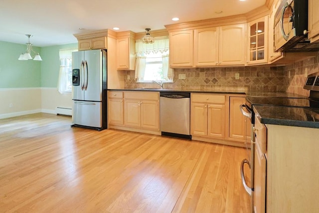 kitchen featuring stainless steel appliances, a baseboard radiator, light brown cabinets, dark countertops, and baseboards