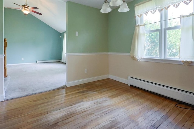 empty room with a baseboard radiator, a ceiling fan, hardwood / wood-style floors, baseboards, and lofted ceiling