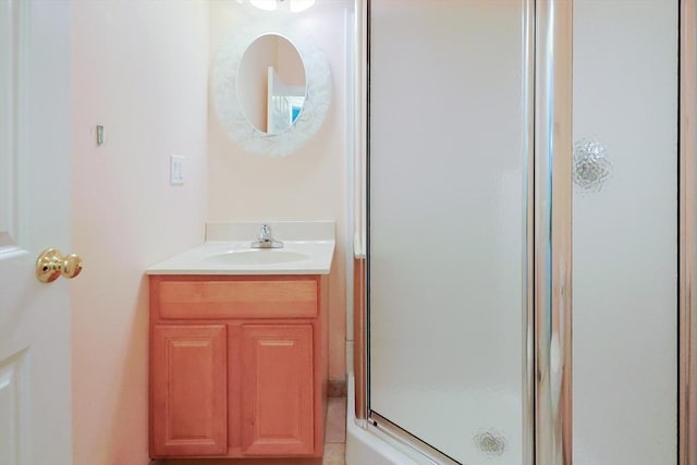 bathroom featuring a stall shower and vanity