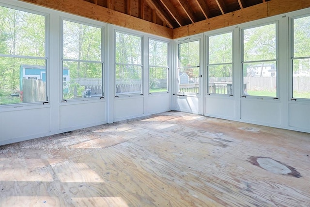 unfurnished sunroom with vaulted ceiling