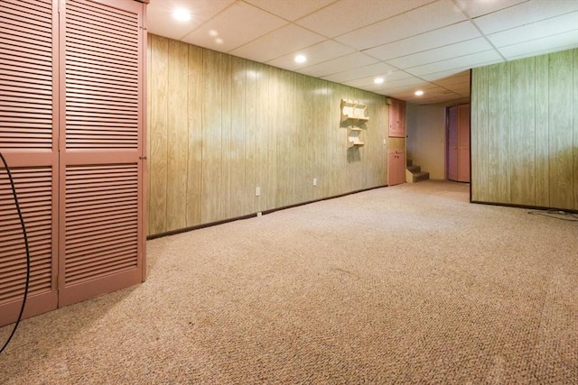 finished below grade area featuring stairway, carpet, a drop ceiling, and recessed lighting