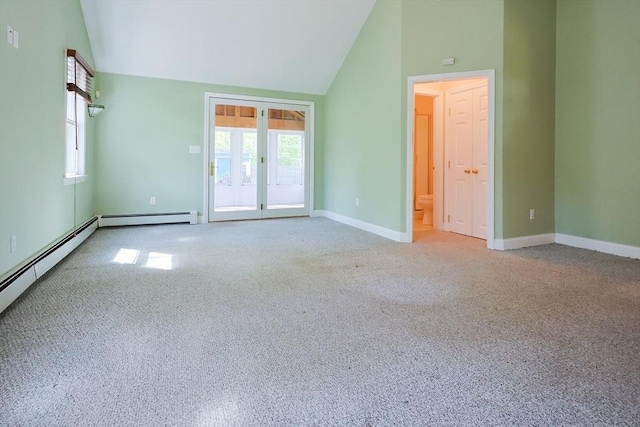 carpeted empty room with baseboards, baseboard heating, and high vaulted ceiling