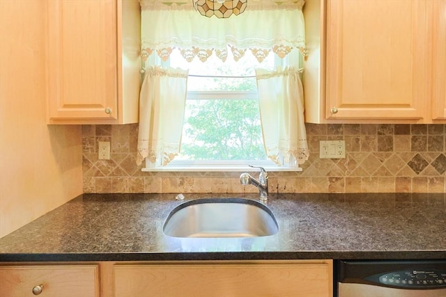 kitchen featuring a sink, plenty of natural light, tasteful backsplash, and stainless steel dishwasher