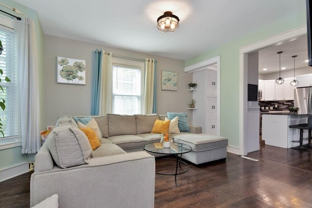 living area with baseboards, recessed lighting, and dark wood-style floors