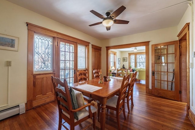 dining room with ceiling fan, dark wood-type flooring, and a baseboard radiator