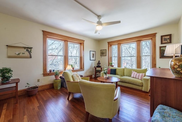 sitting room featuring a healthy amount of sunlight, baseboards, and hardwood / wood-style flooring