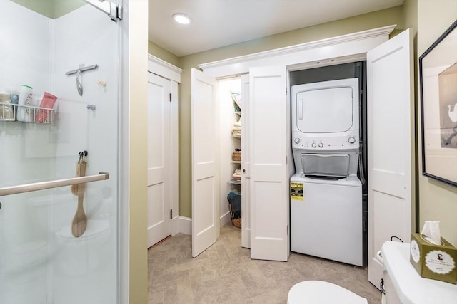 laundry area with stacked washer and dryer and laundry area