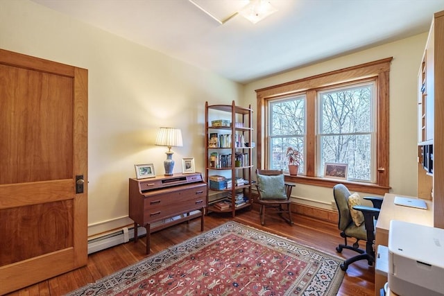 office space with a baseboard heating unit and wood finished floors