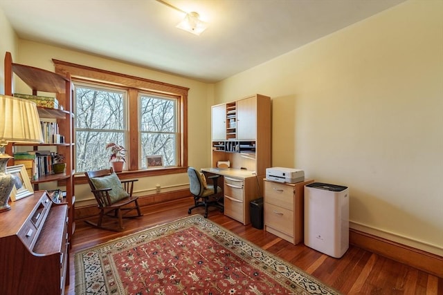 home office with baseboards and wood finished floors