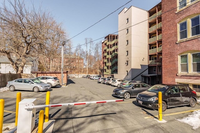 exterior space featuring uncovered parking and fence