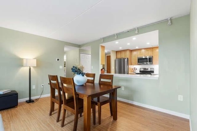200 Ledgewood Dr Unit 604, Stoneham, MA 02180 - dining room featuring rail lighting and light wood finished floors