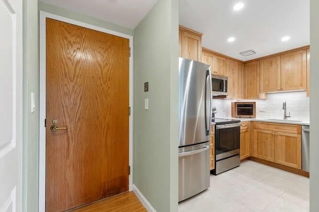 200 Ledgewood Dr Unit 604, Stoneham, MA 02180 - kitchen featuring stainless steel appliances, light countertops, recessed lighting, and backsplash