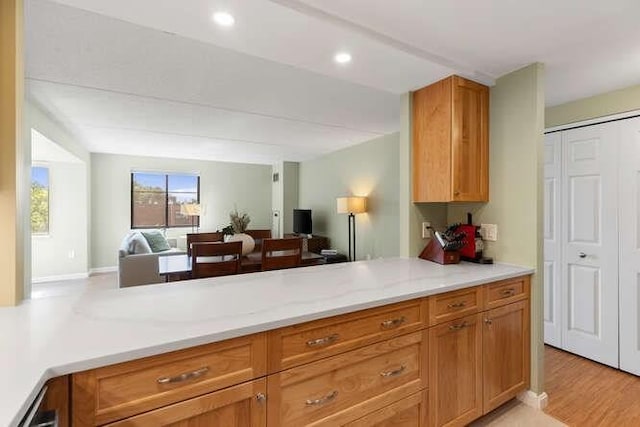 200 Ledgewood Dr Unit 604, Stoneham, MA 02180 - kitchen with open floor plan, light wood-style floors, recessed lighting, and brown cabinetry