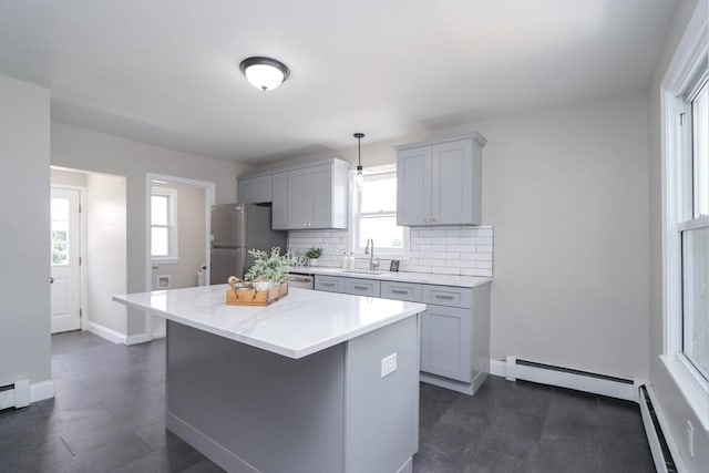 7 Dewey Ave, East Longmeadow, MA 01028 - kitchen with freestanding refrigerator, a baseboard heating unit, gray cabinets, decorative backsplash, and a center island