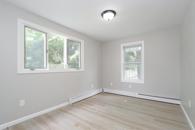 7 Dewey Ave, East Longmeadow, MA 01028 - empty room with wood finished floors and a baseboard heating unit