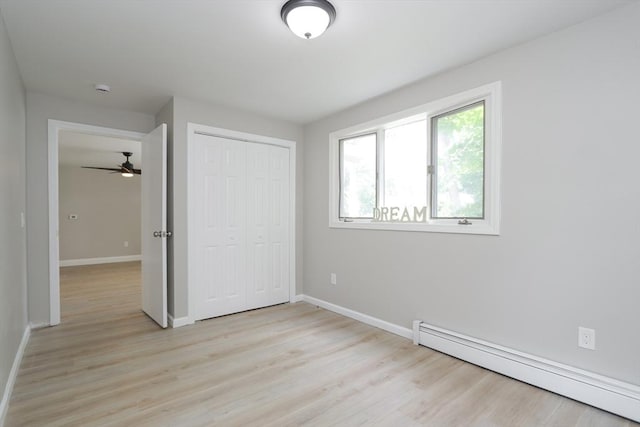 7 Dewey Ave, East Longmeadow, MA 01028 - unfurnished bedroom with a baseboard heating unit, a closet, and light wood-style floors