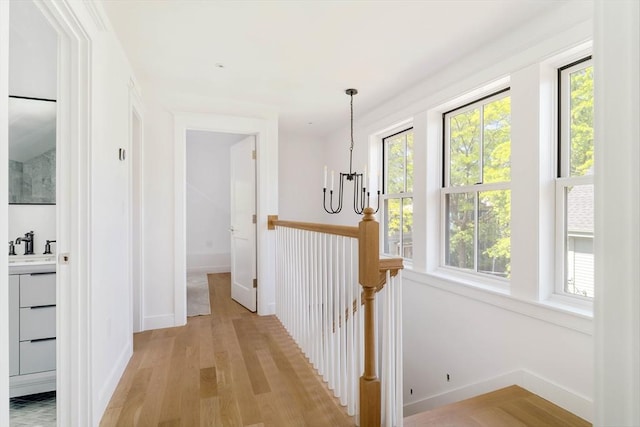 13 Mellen St, Cambridge, MA 02138 - corridor featuring a chandelier, plenty of natural light, light wood finished floors, and an upstairs landing