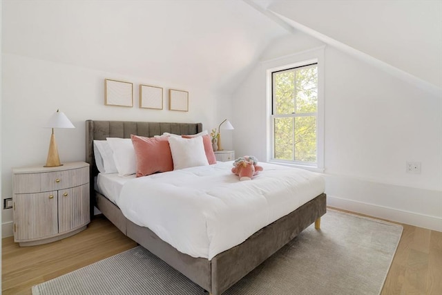 13 Mellen St, Cambridge, MA 02138 - bedroom featuring light wood-style floors, vaulted ceiling, and baseboards