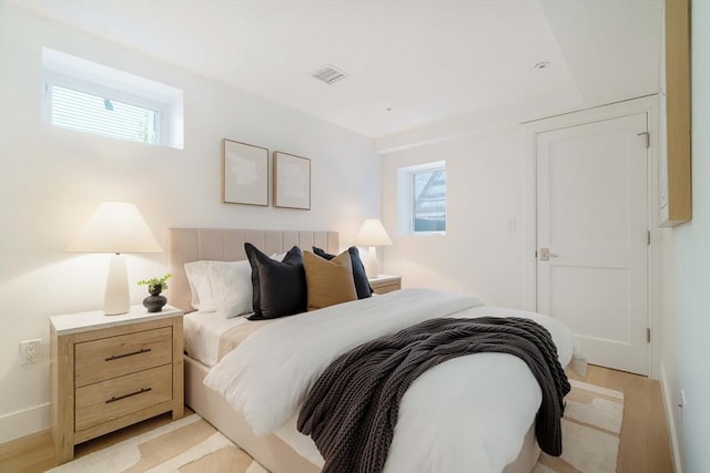 13 Mellen St, Cambridge, MA 02138 - bedroom with light wood-style flooring and baseboards