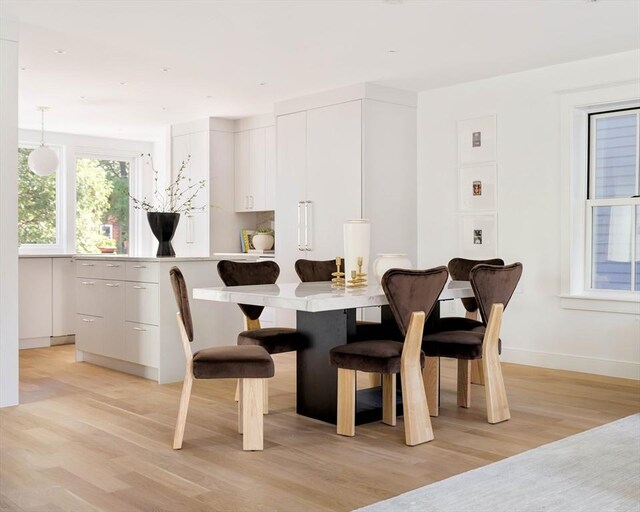 13 Mellen St, Cambridge, MA 02138 - dining space featuring light wood-style flooring and baseboards