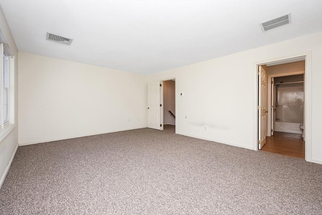 carpeted spare room with visible vents