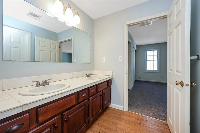 full bathroom featuring visible vents, a sink, and double vanity