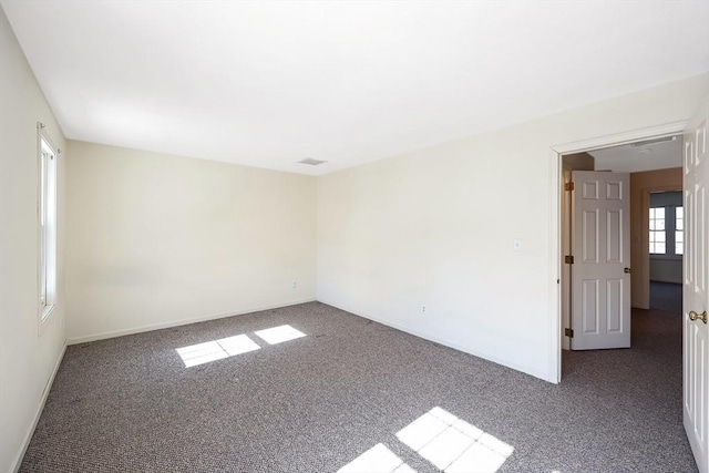 carpeted empty room with baseboards