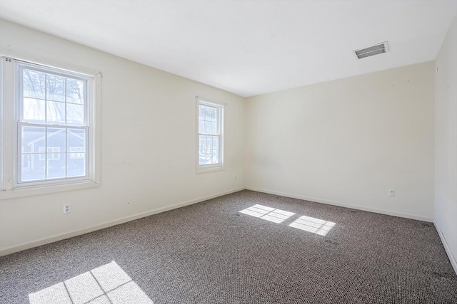 carpeted spare room with baseboards and visible vents