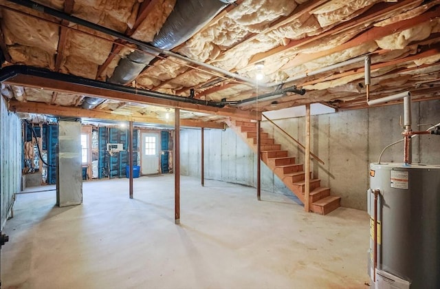 basement featuring water heater and stairway