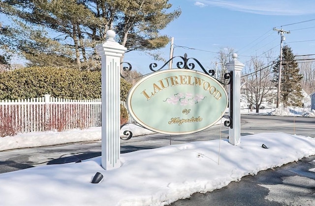 community / neighborhood sign with fence