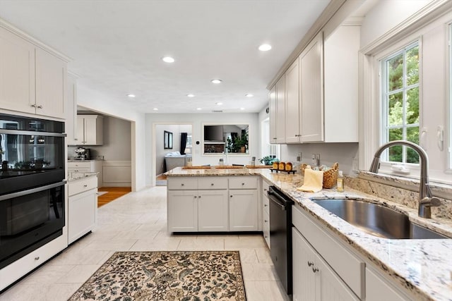 51 Lilah Ln, Reading, MA 01867 - kitchen with a sink, dishwasher, double oven, a peninsula, and recessed lighting