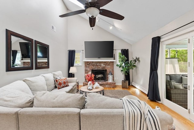 51 Lilah Ln, Reading, MA 01867 - living room with a baseboard radiator, light wood-style floors, a ceiling fan, high vaulted ceiling, and track lighting