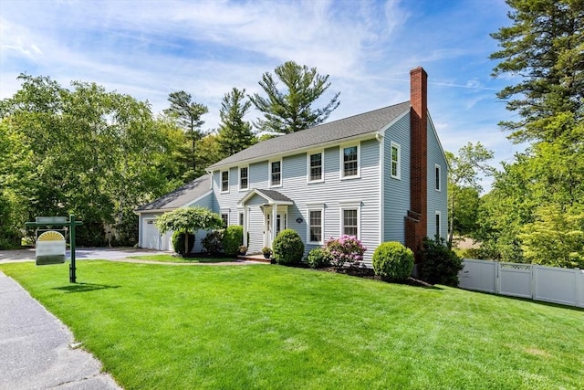 51 Lilah Ln, Reading, MA 01867 - colonial house featuring a chimney, driveway, and a garage