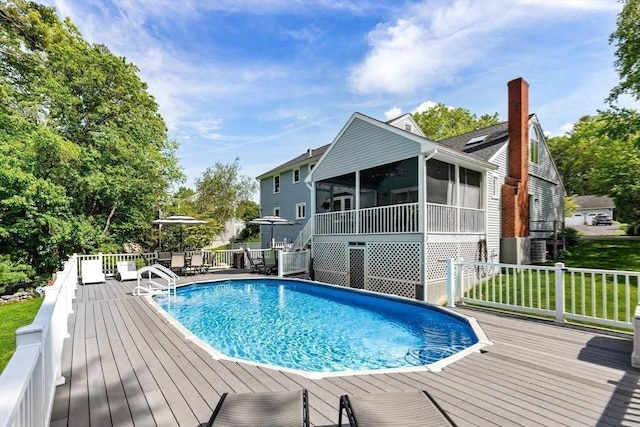 51 Lilah Ln, Reading, MA 01867 - view of swimming pool with a deck, a sunroom, and a lawn