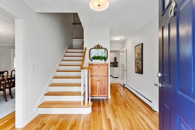 51 Lilah Ln, Reading, MA 01867 - entrance foyer featuring a baseboard heating unit, light wood finished floors, and stairs