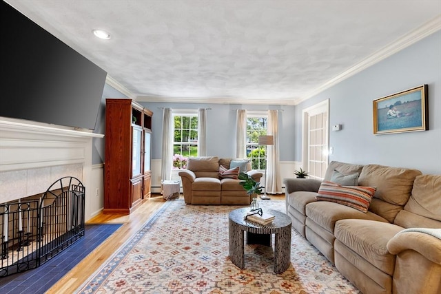 51 Lilah Ln, Reading, MA 01867 - living area with a tile fireplace, wood finished floors, crown molding, and baseboard heating