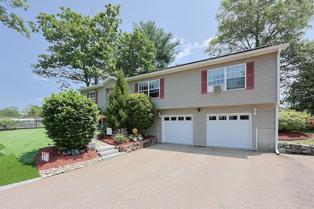 4 Colonial Rd, Webster, MA 01570 - view of front facade featuring asphalt driveway, a garage, and a front lawn
