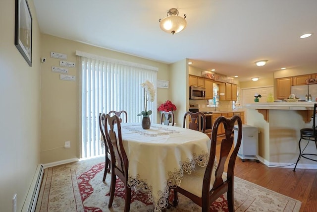4 Colonial Rd, Webster, MA 01570 - dining room with a baseboard heating unit, light wood finished floors, and recessed lighting