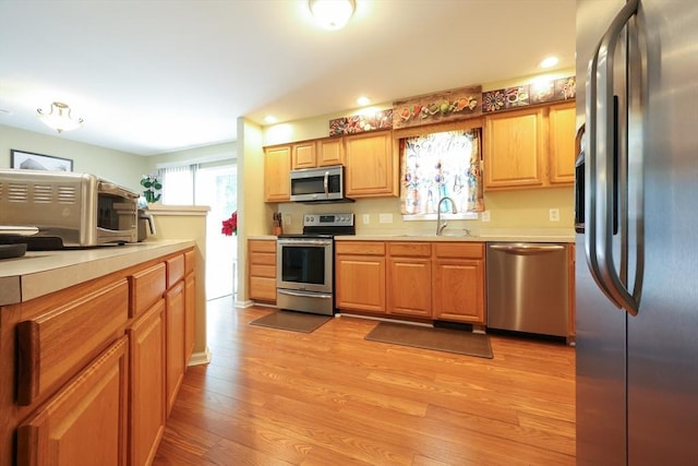4 Colonial Rd, Webster, MA 01570 - kitchen with appliances with stainless steel finishes, light countertops, light wood-type flooring, and recessed lighting
