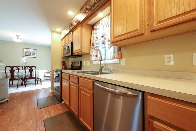 4 Colonial Rd, Webster, MA 01570 - kitchen with appliances with stainless steel finishes, dark wood-style floors, light countertops, and recessed lighting