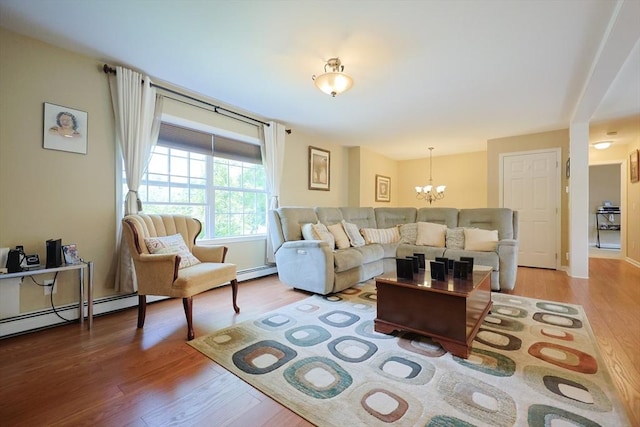4 Colonial Rd, Webster, MA 01570 - living room featuring light wood-style flooring, a chandelier, and a baseboard heating unit